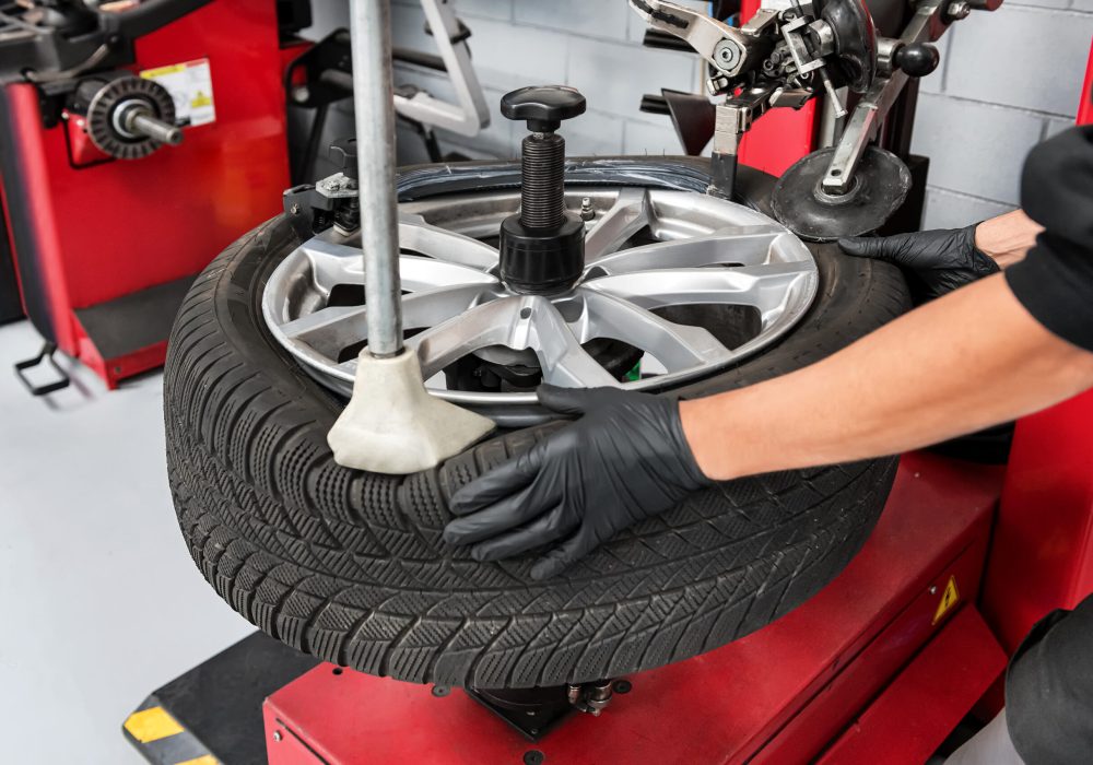 Mechanic removing tire from wheel